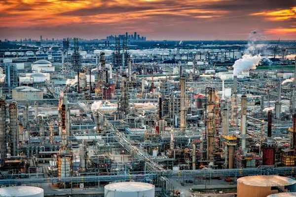A view of a petrochemical plant with a skyline in the background