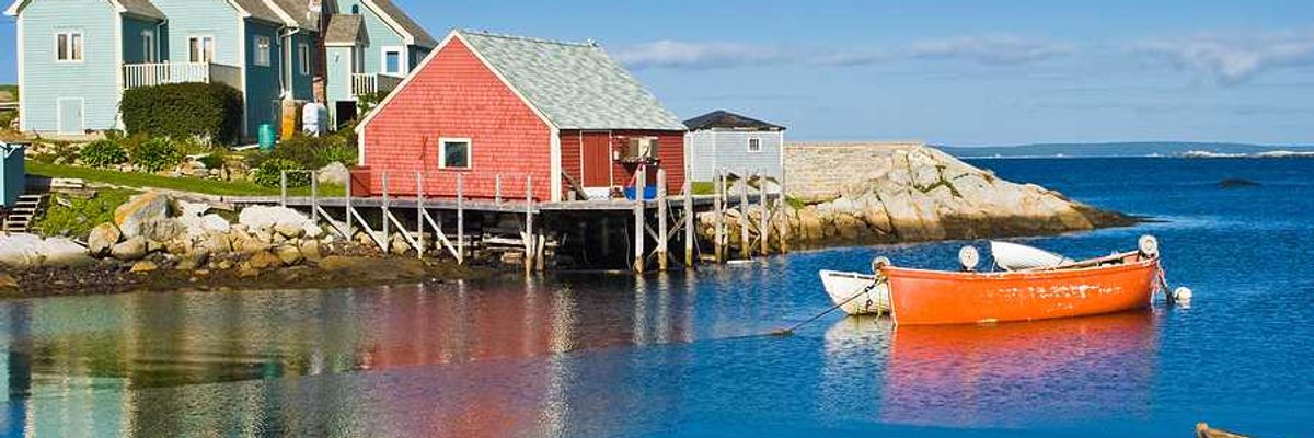 A view of a red fisherman's hut on the water in Nova Scotia