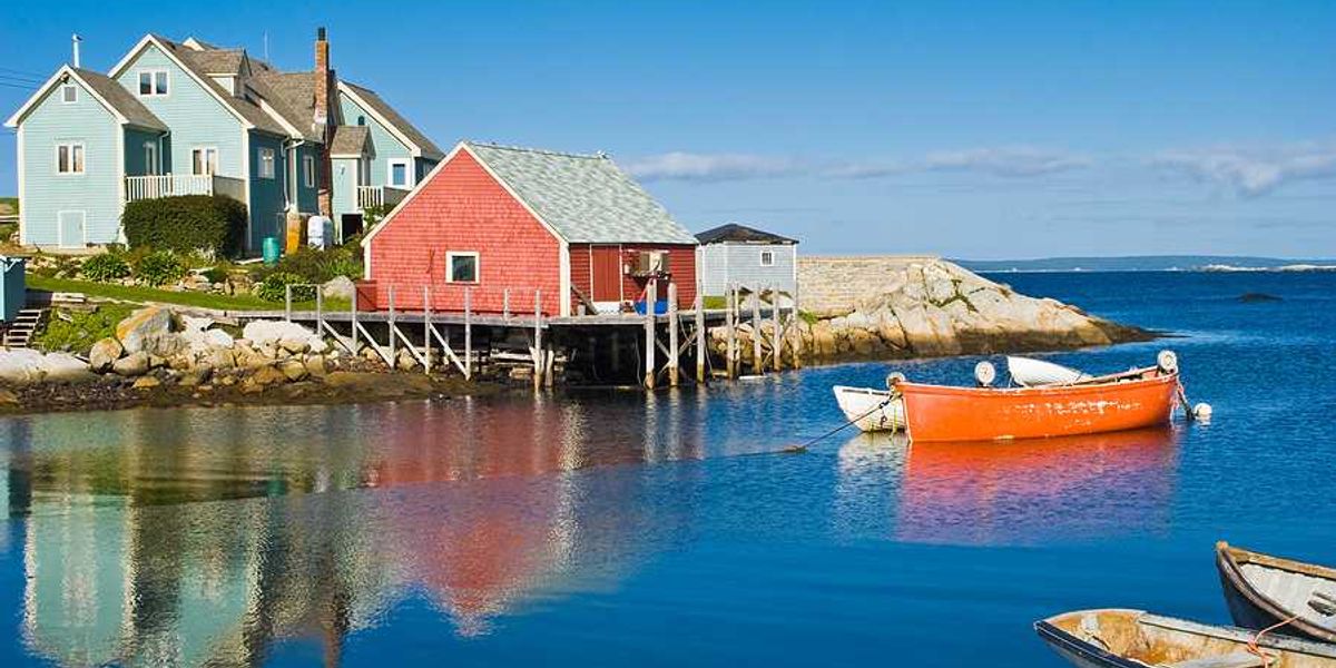 A view of a red fisherman's hut on the water in Nova Scotia