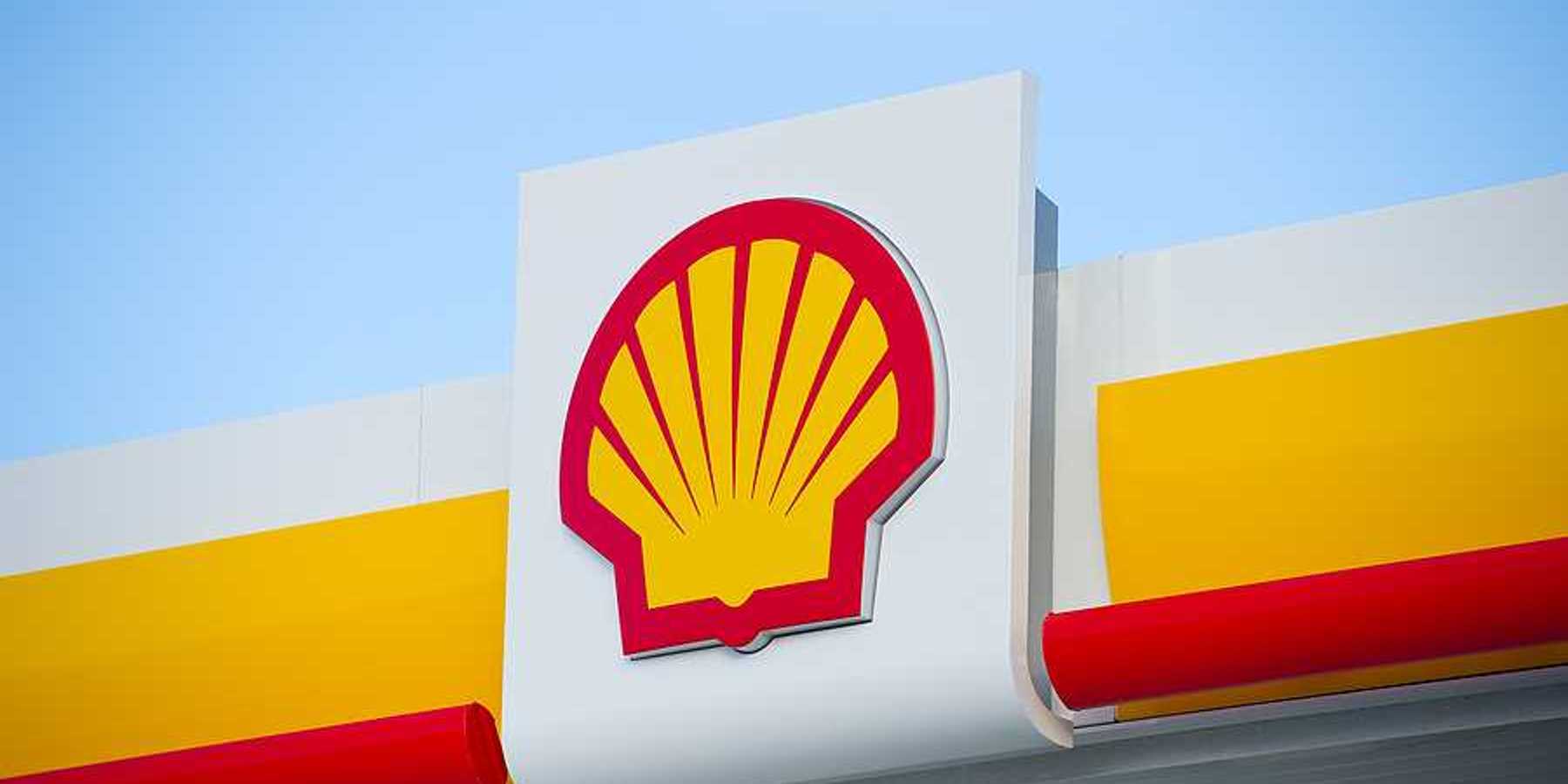 A view of a sign with the Shell Oil logo on it in red and yellow in the shape of a shell