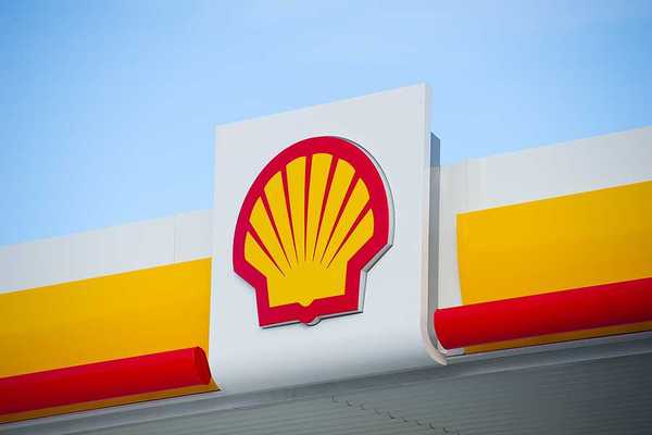 A view of a sign with the Shell Oil logo on it in red and yellow in the shape of a shell