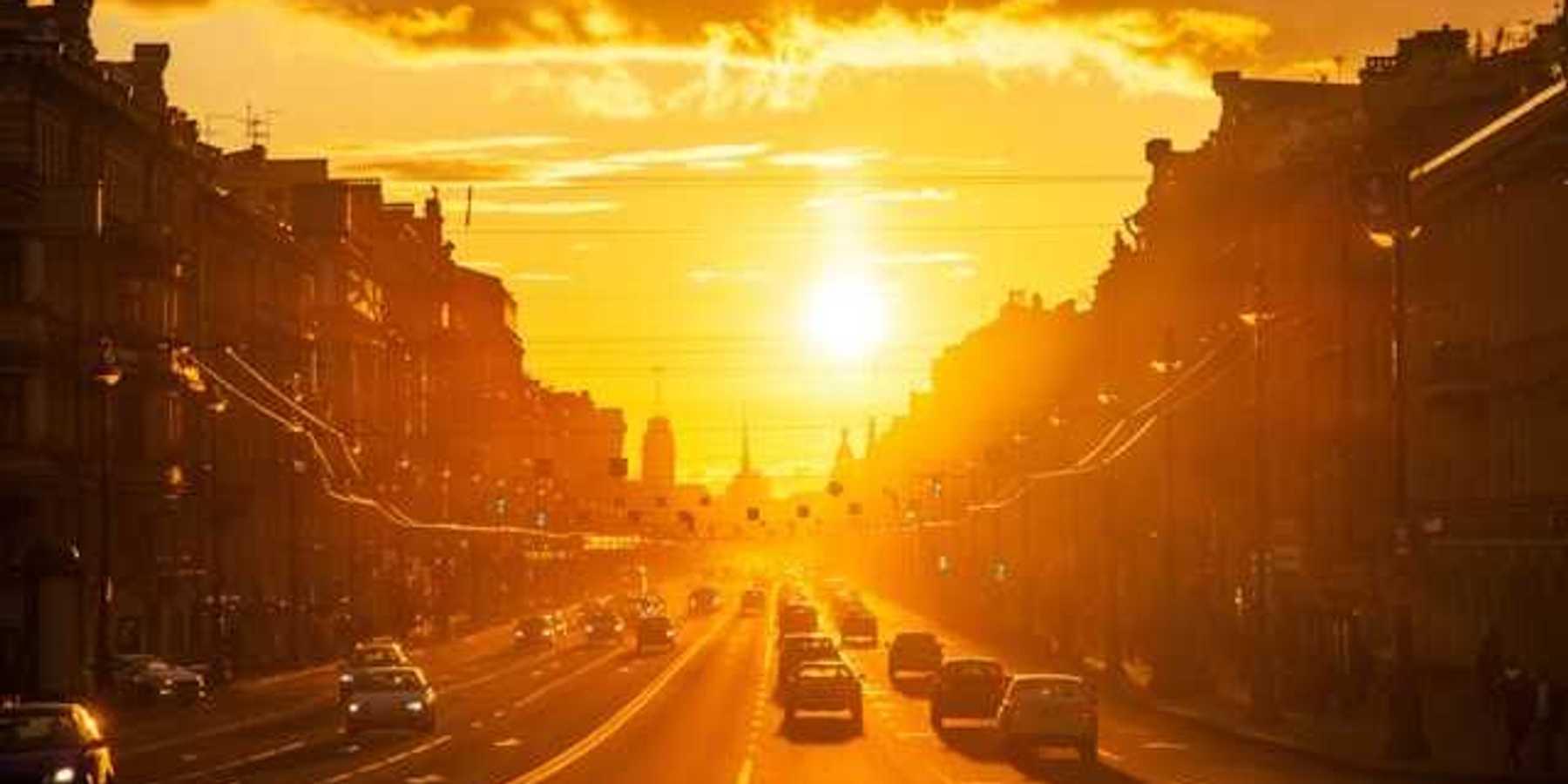 A view of a street in a European city with the setting sun in the background