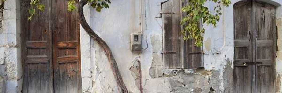 A view of a street with houses with cracked facades