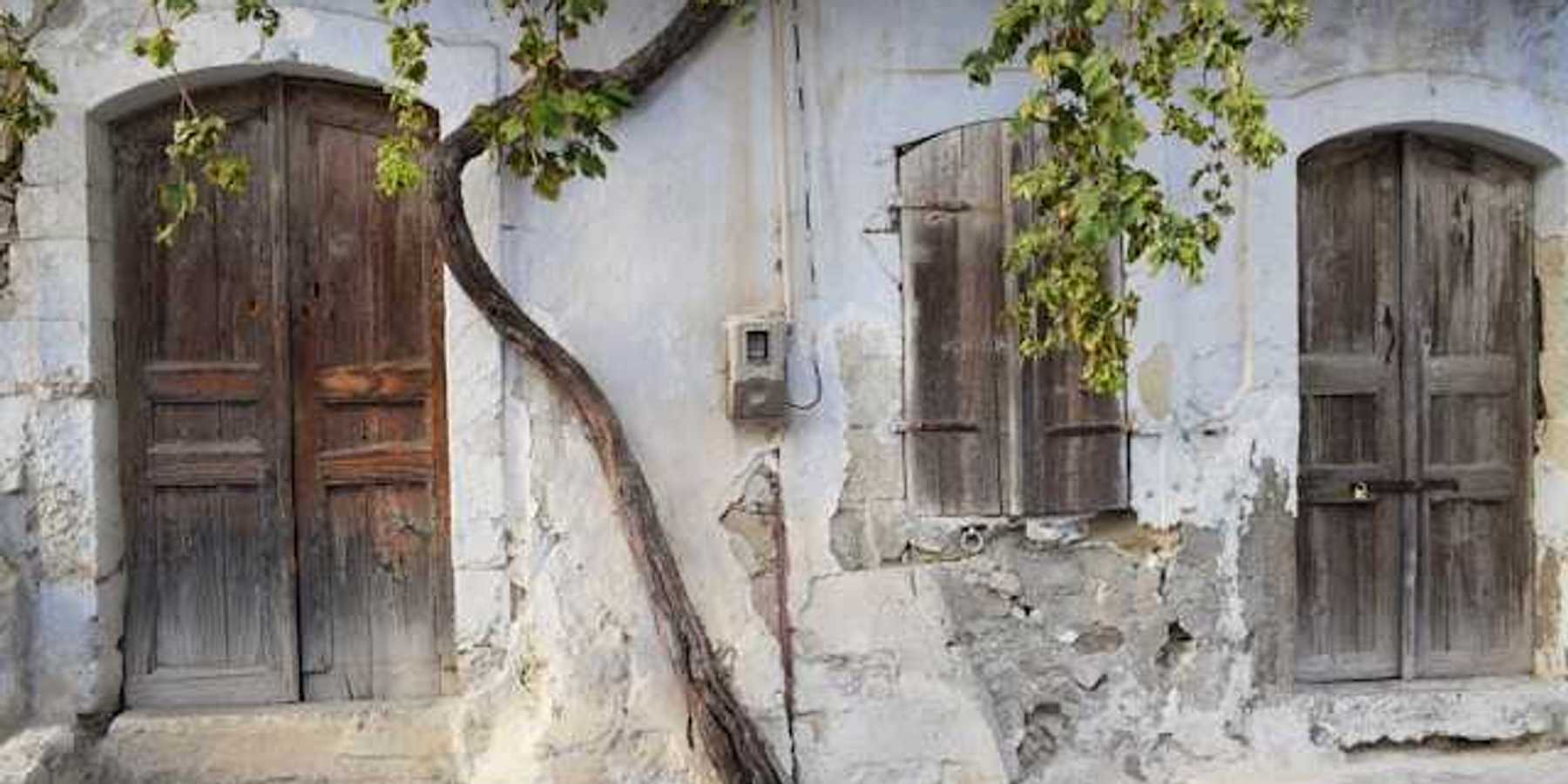 A view of a street with houses with cracked facades