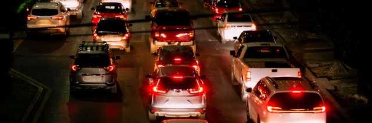 A view of a traffic jam with many cars and red brake lights