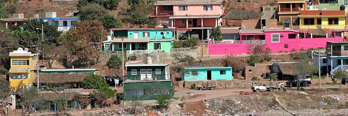 A view of a village on hills above the ocean