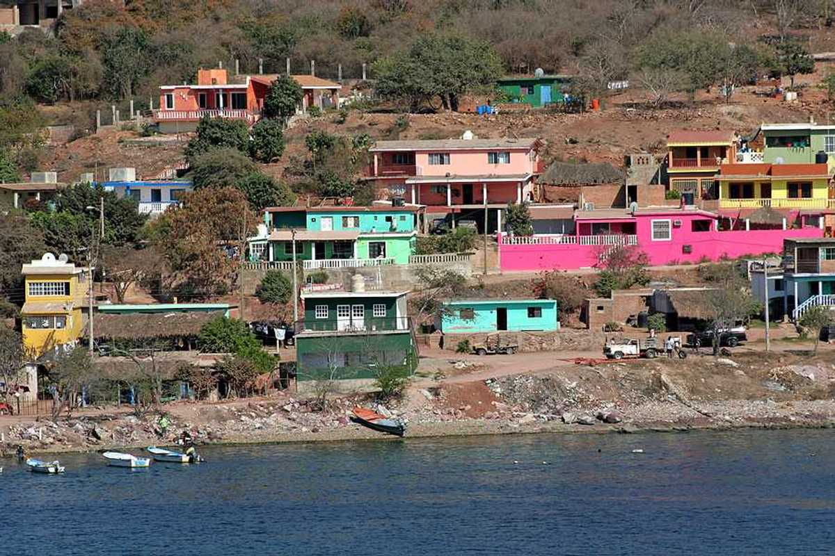 A view of a village on hills above the ocean
