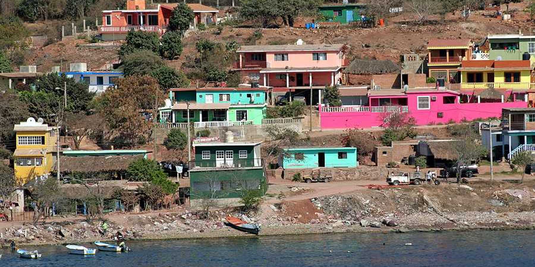 A view of a village on hills above the ocean