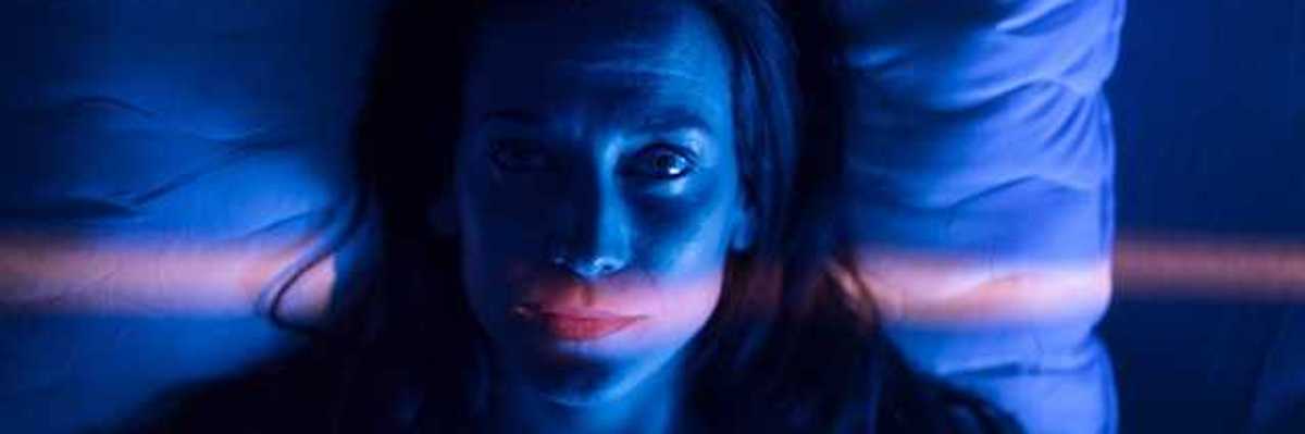 A view of a woman awake in bed