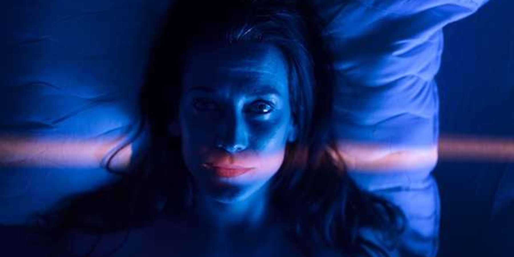 A view of a woman awake in bed