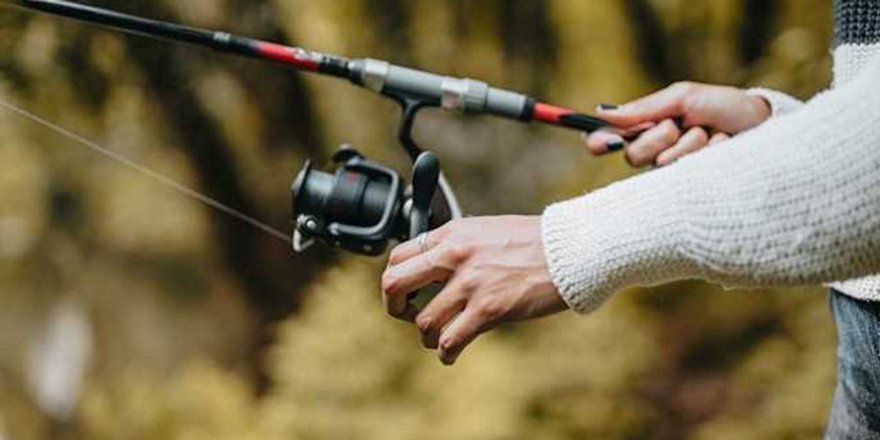 A view of a woman's hands with a fishing pole