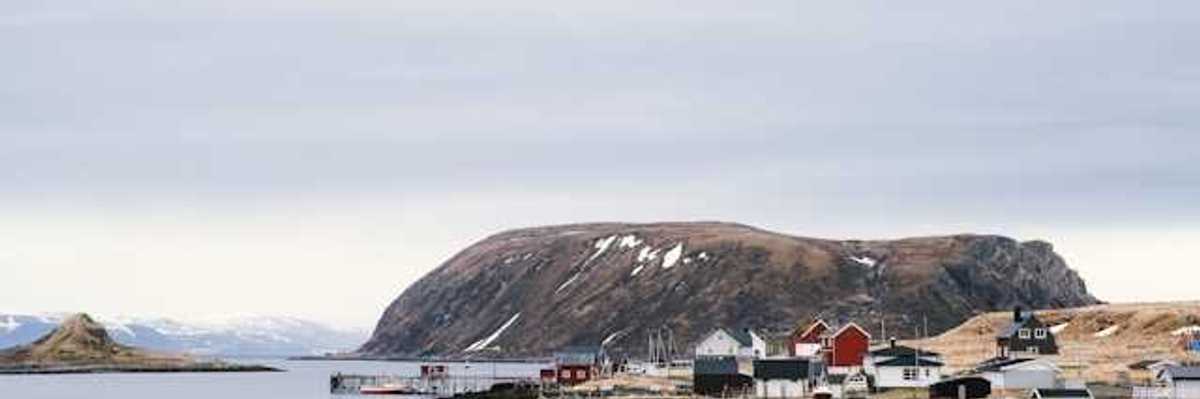 A view of an Alaskan village on the edge of a body of water