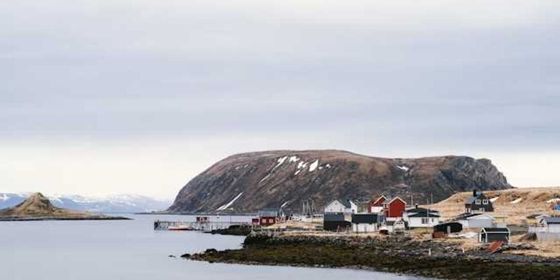 A view of an Alaskan village on the edge of a body of water