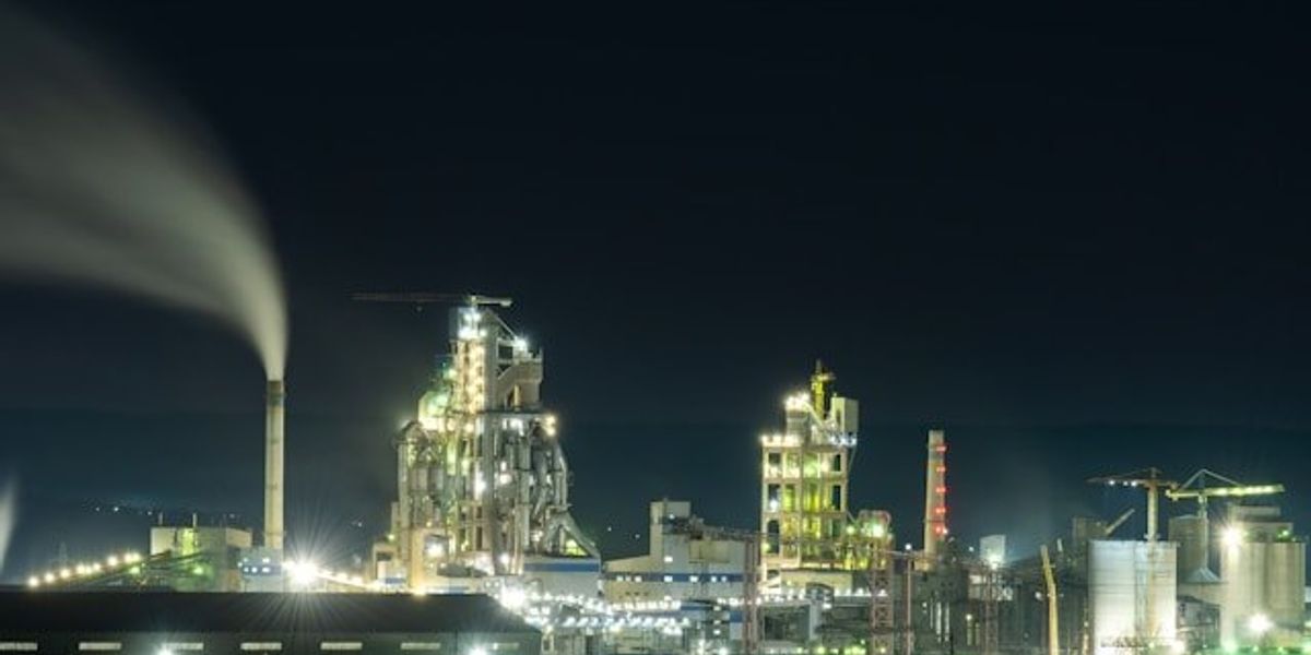 A view of an oil refinery lit up at night.