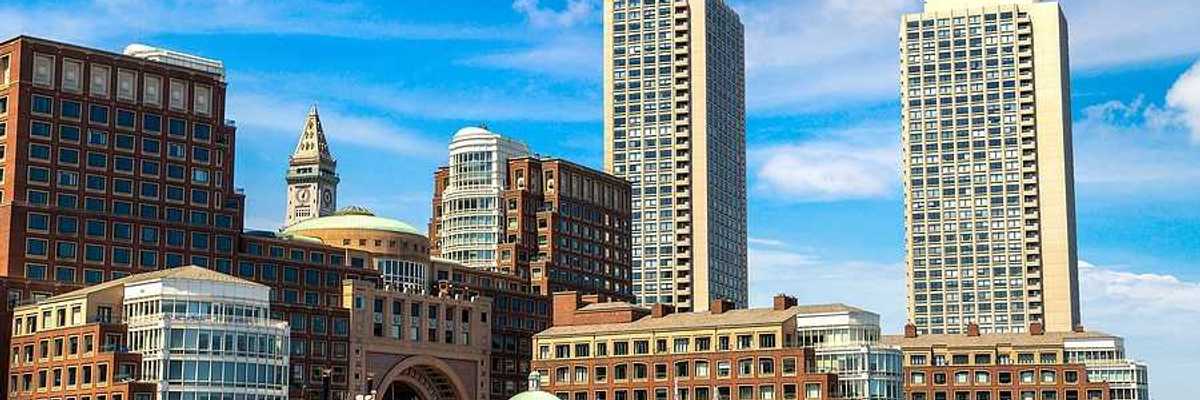 A view of Boston harbor with city buildings in the background
