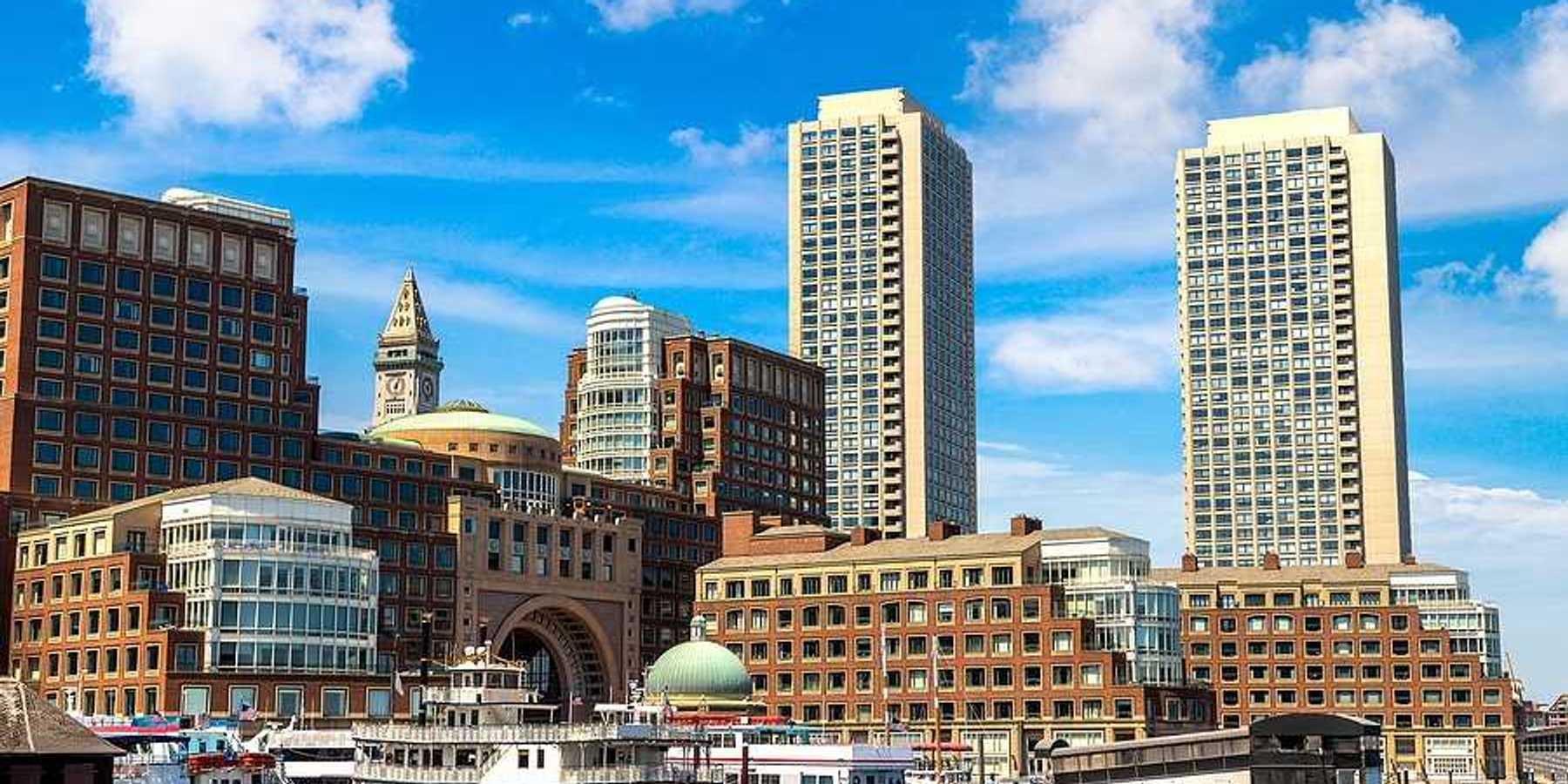 A view of Boston harbor with city buildings in the background