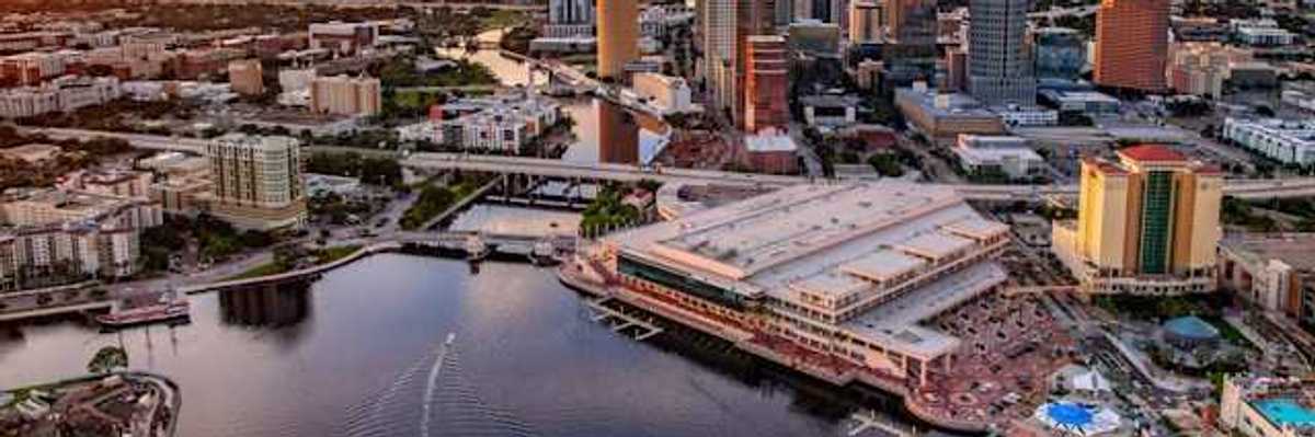 A view of downtown Tampa, Florida along the Hillsborough river against a night sky