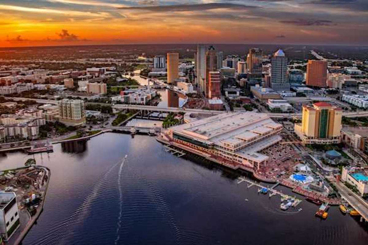 A view of downtown Tampa, Florida along the Hillsborough river against a night sky