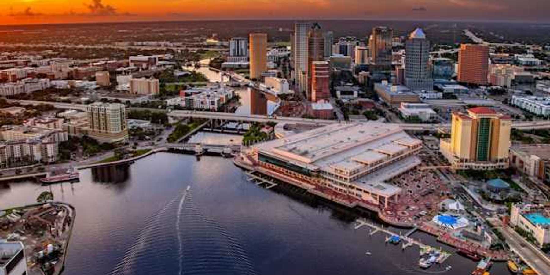 A view of downtown Tampa, Florida along the Hillsborough river against a night sky