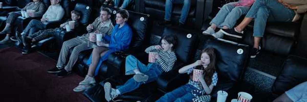 A view of people sitting in a movie theater watching a movie