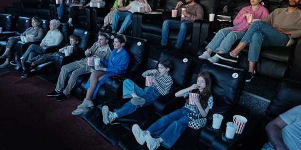 A view of people sitting in a movie theater watching a movie