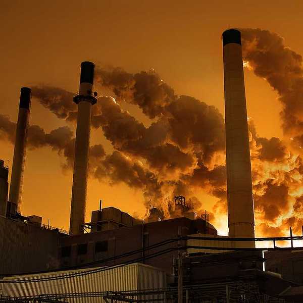 A view of smokestacks emitting smoke into the air