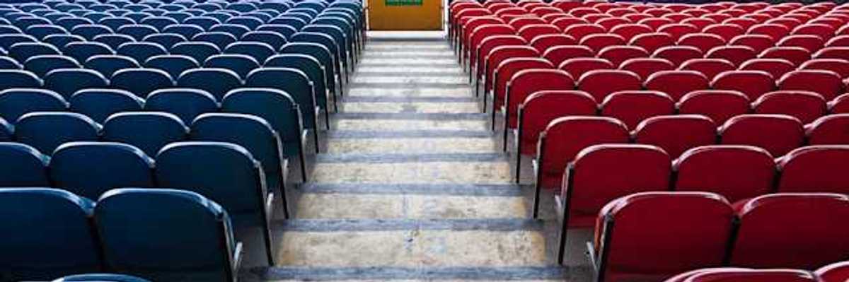 A view of stadium seats leading to a green field