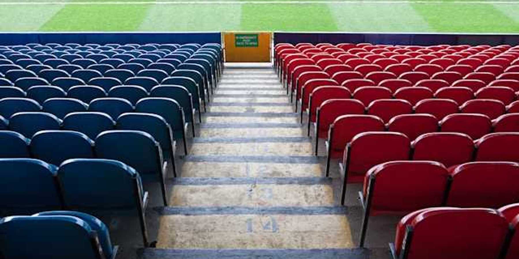 A view of stadium seats leading to a green field