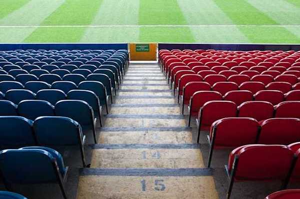 A view of stadium seats leading to a green field
