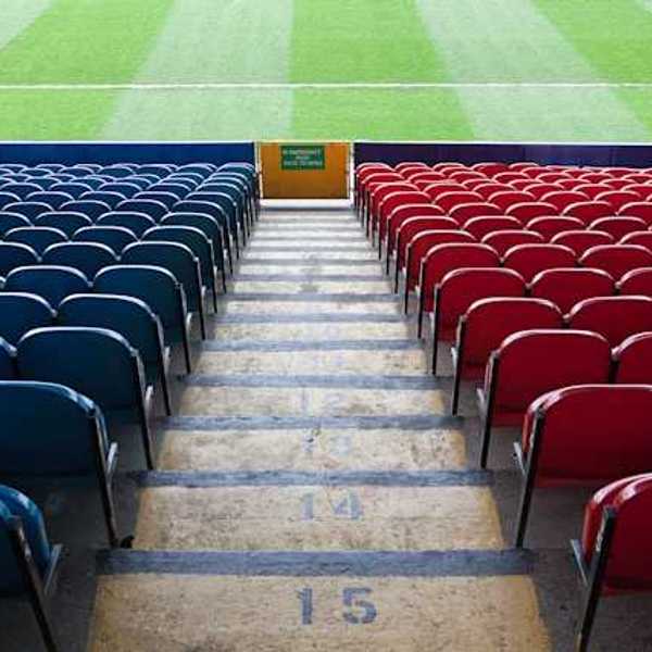 A view of stadium seats leading to a green field
