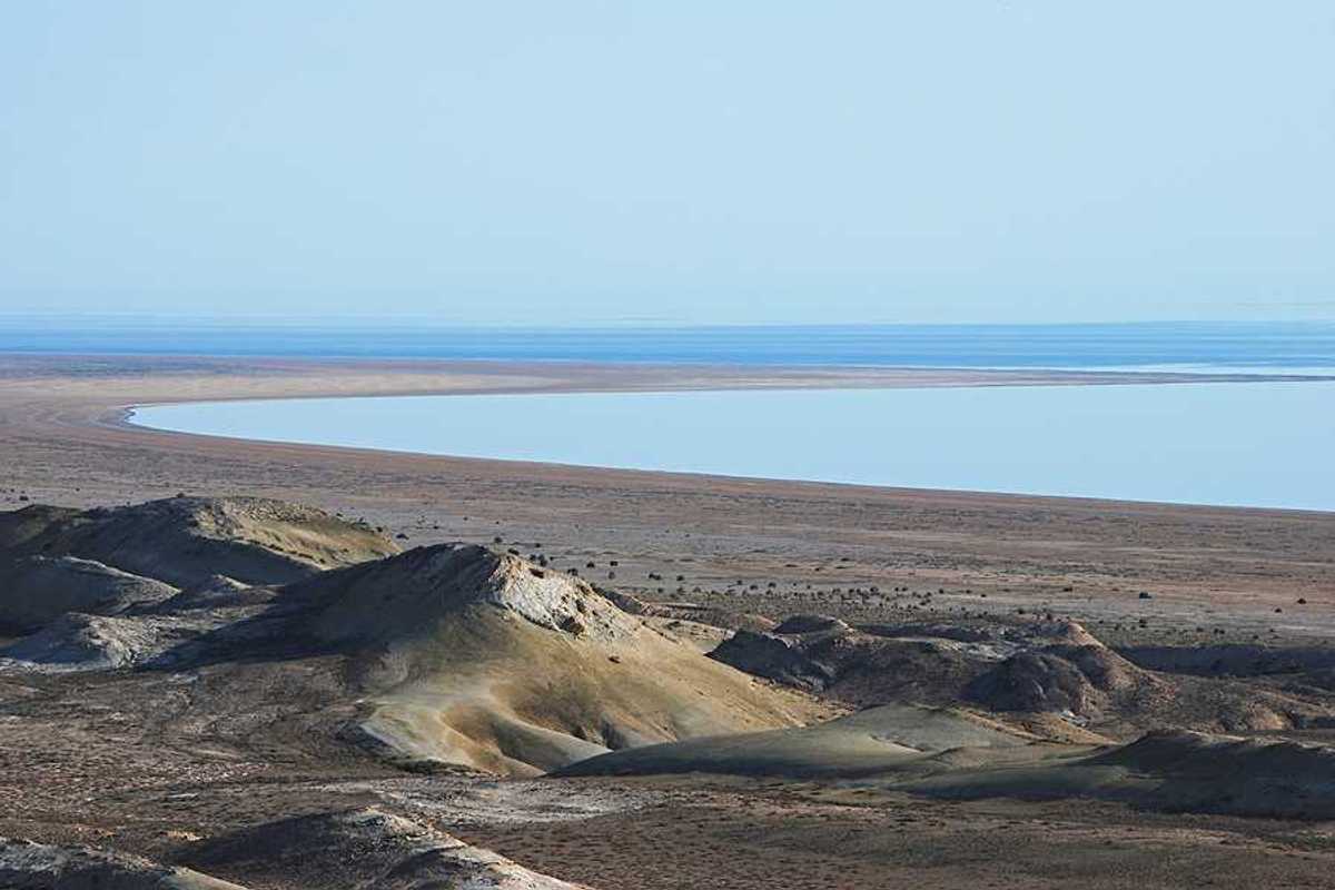 A view of the Aral Sea in Uzbekistan showing the water receding from a dry environment