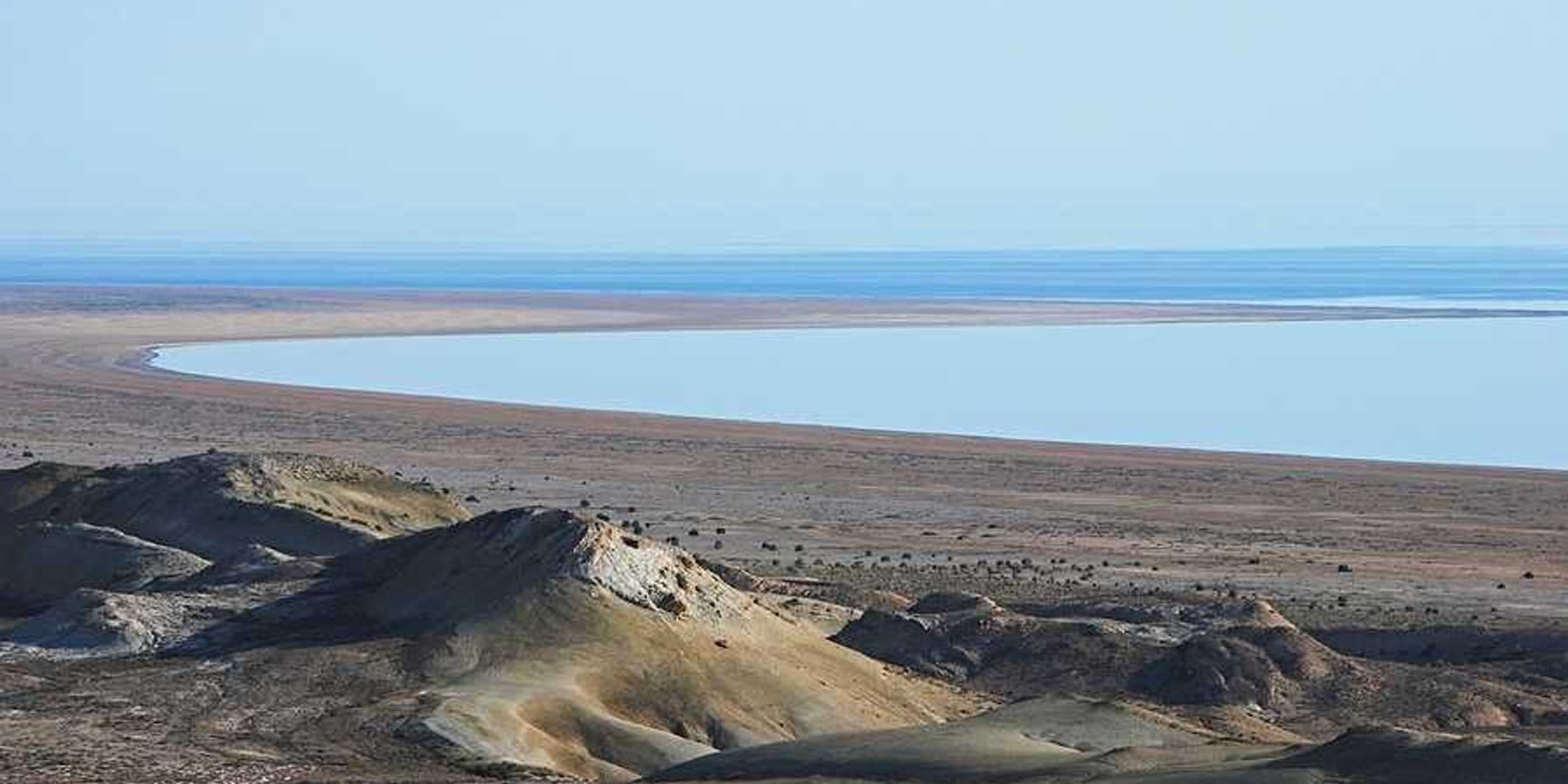 A view of the Aral Sea in Uzbekistan showing the water receding from a dry environment
