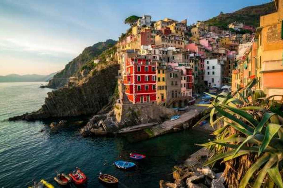 A view of the coastline of Cinque Terre with colorful buildings lining a hillside above the water
