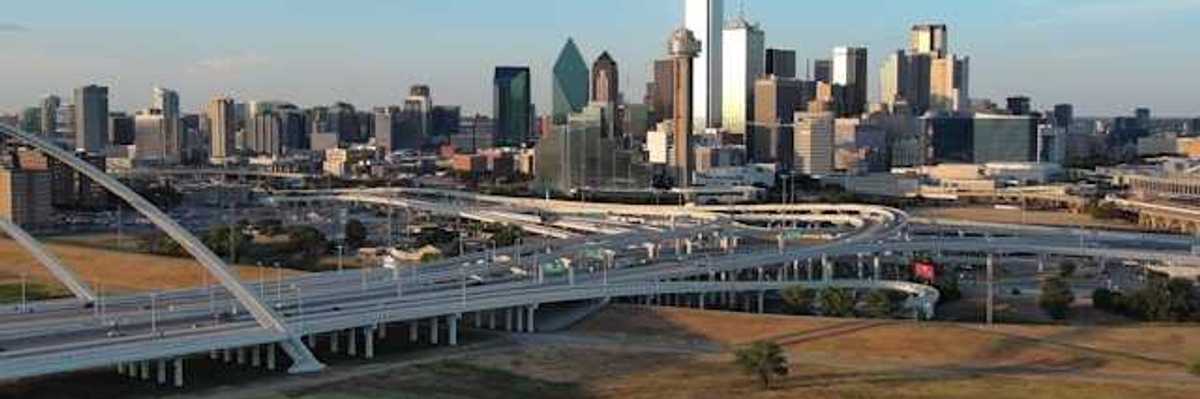 A view of the Dallas skyline with freeways in the foreground