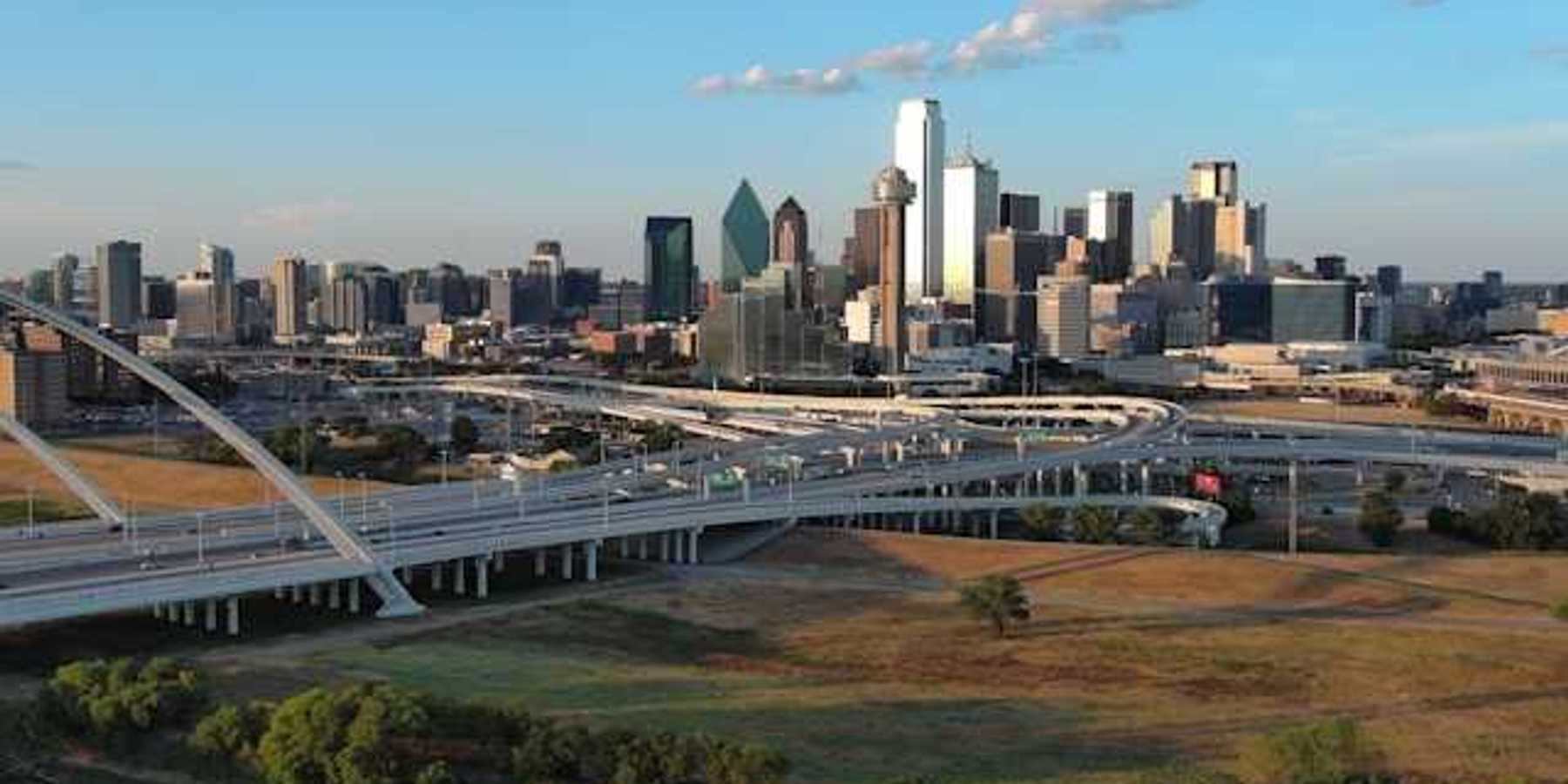 A view of the Dallas skyline with freeways in the foreground