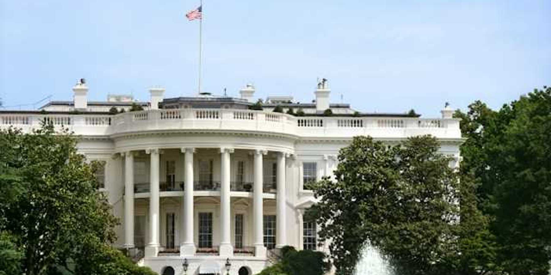 A view of the front of the White House on a sunny day