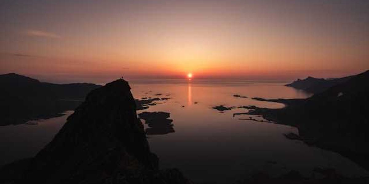 A view of the ocean with a sunset in the background