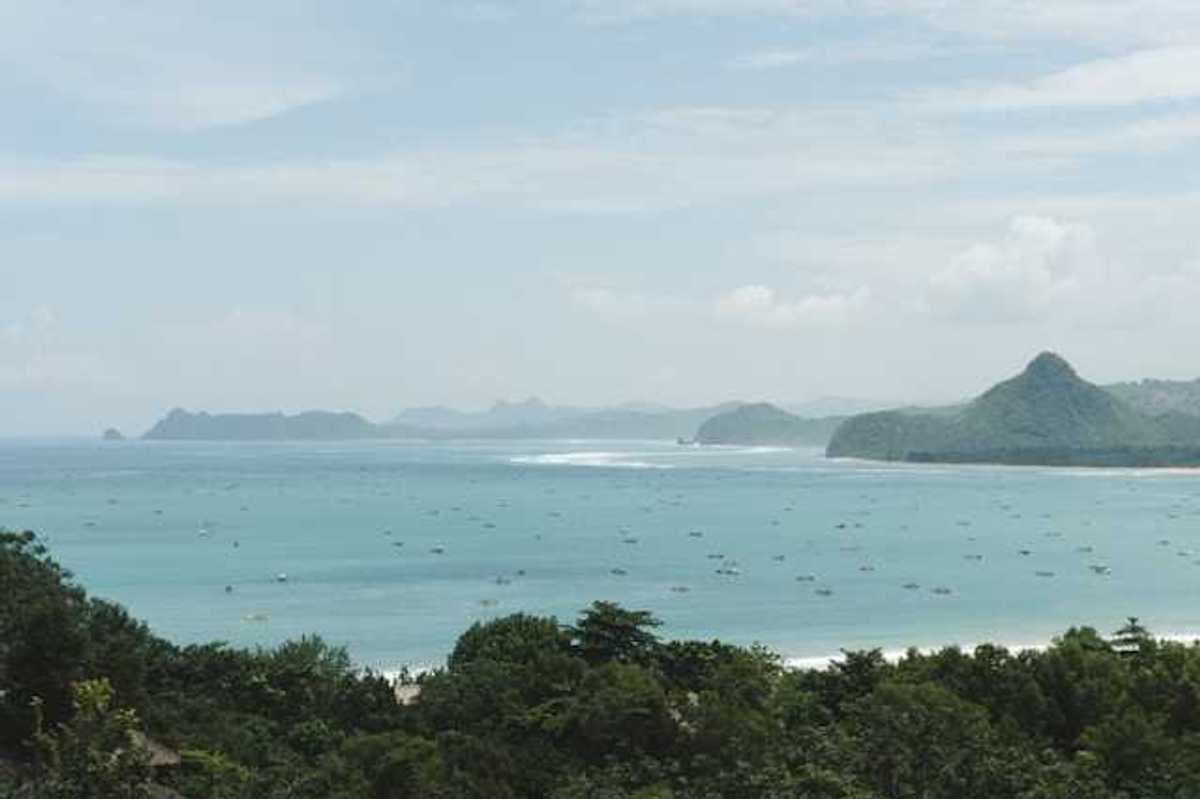A view of turquoise water and a tropical island