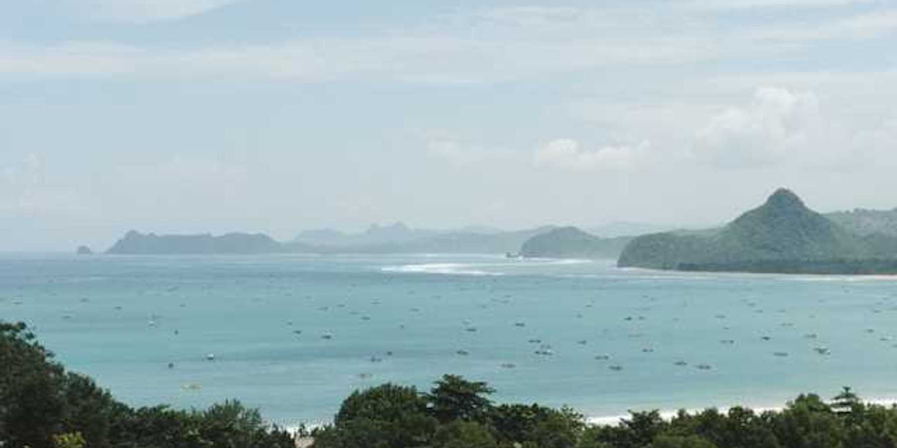 A view of turquoise water and a tropical island