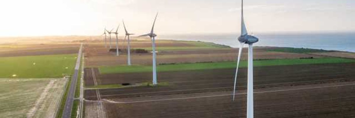 A view of wind turbines situated along the ocean