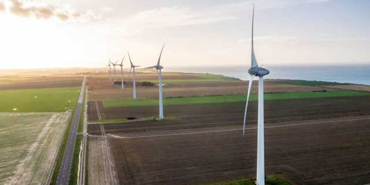A view of wind turbines situated along the ocean