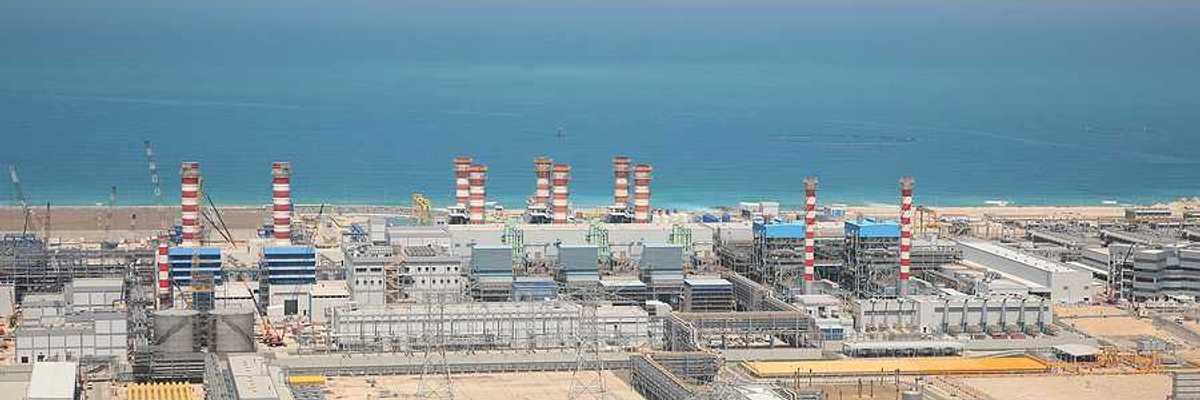 A water desalination plant in the desert next to a body of water