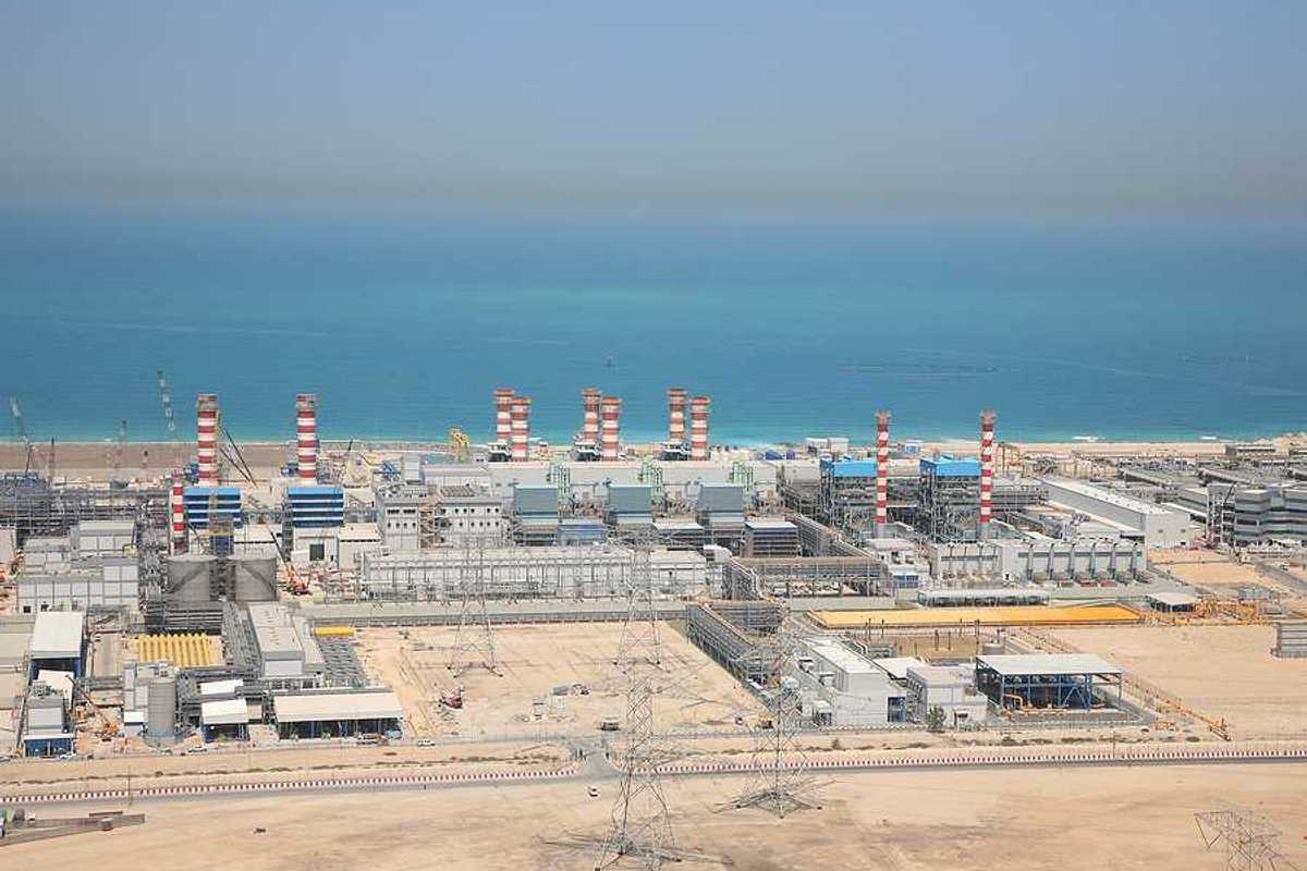A water desalination plant in the desert next to a body of water