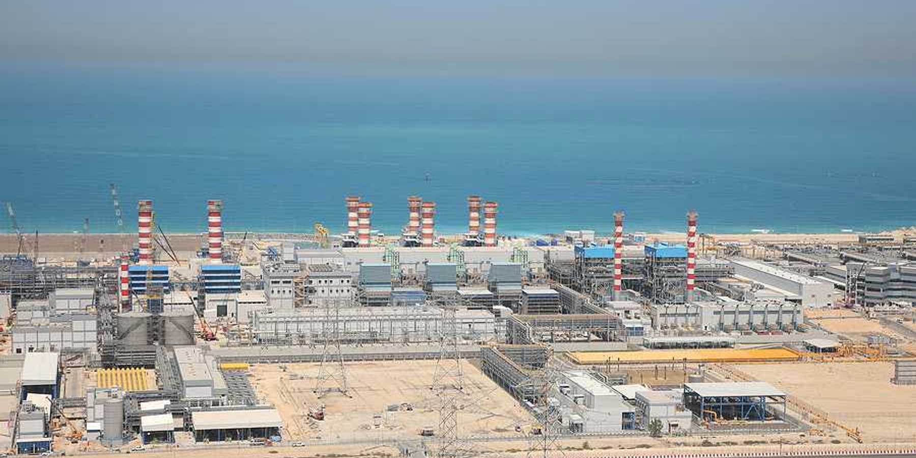A water desalination plant in the desert next to a body of water
