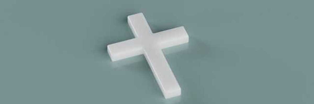 A white cross sitting on a green background