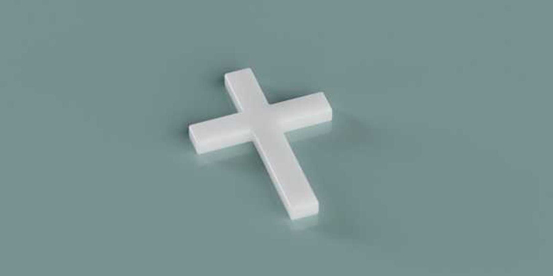 A white cross sitting on a green background