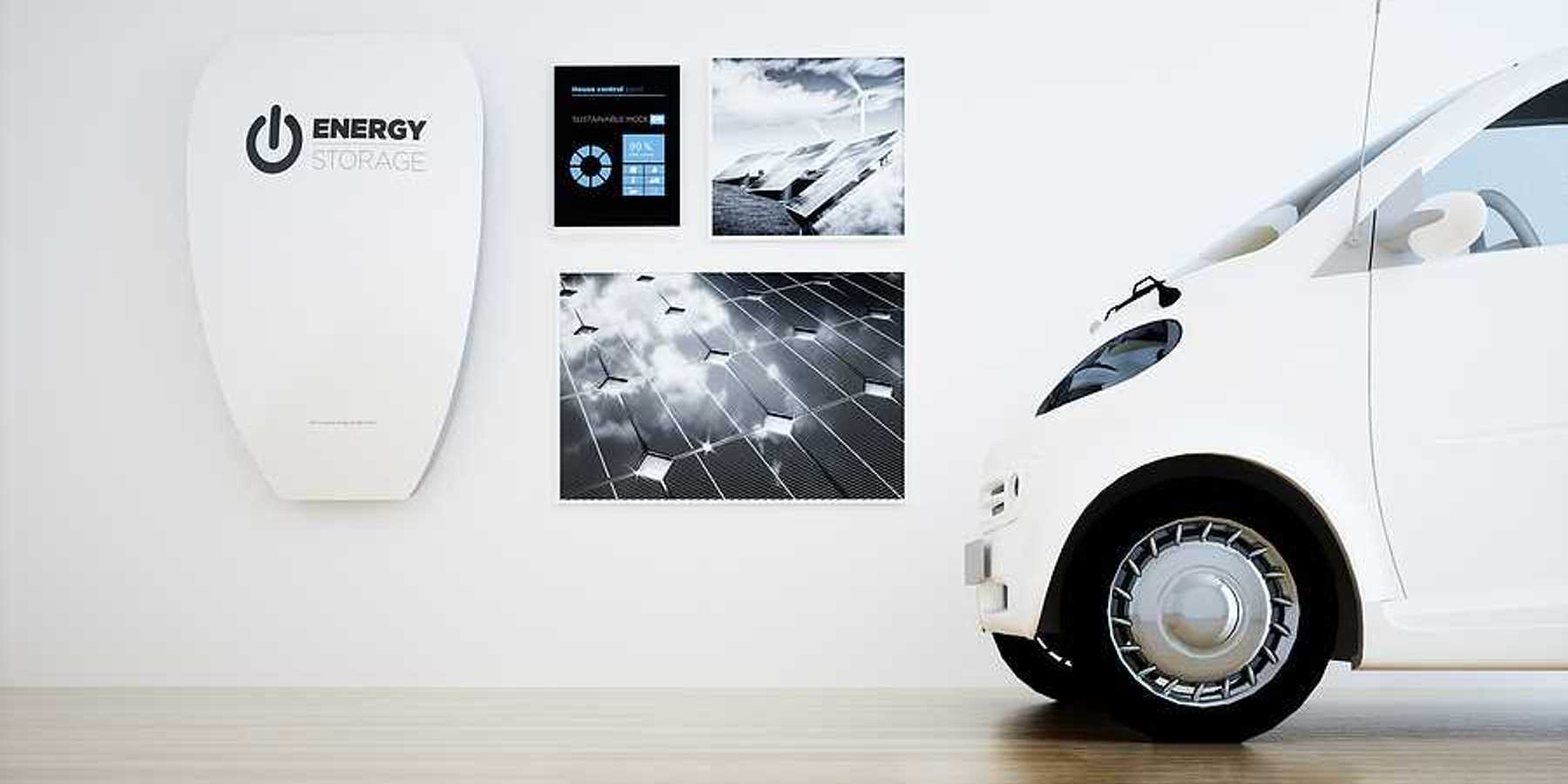 A white home energy battery installed on a wall next to a small white electric vehicle