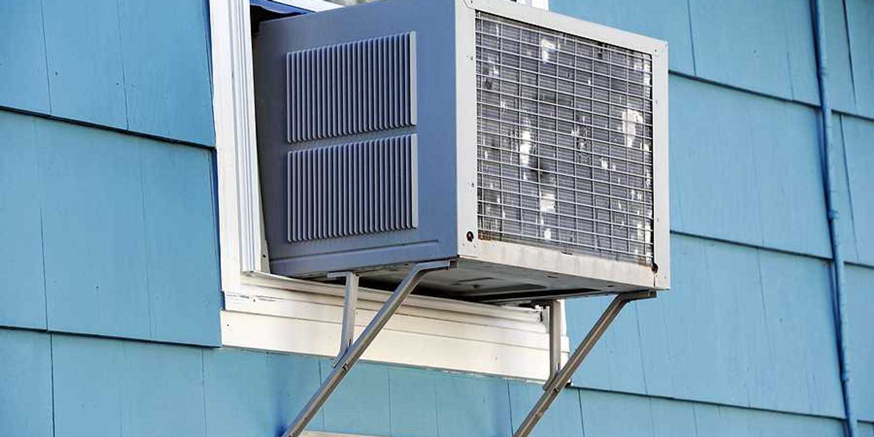 A window air conditioner viewed from the outside of a house