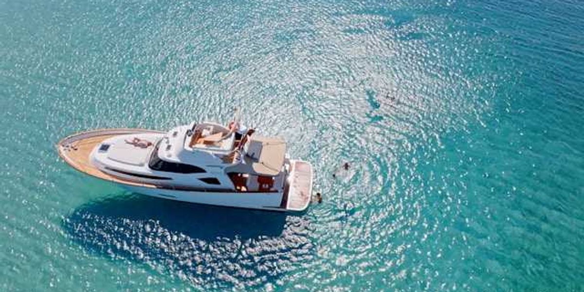 A yacht anchored in aqua blue water