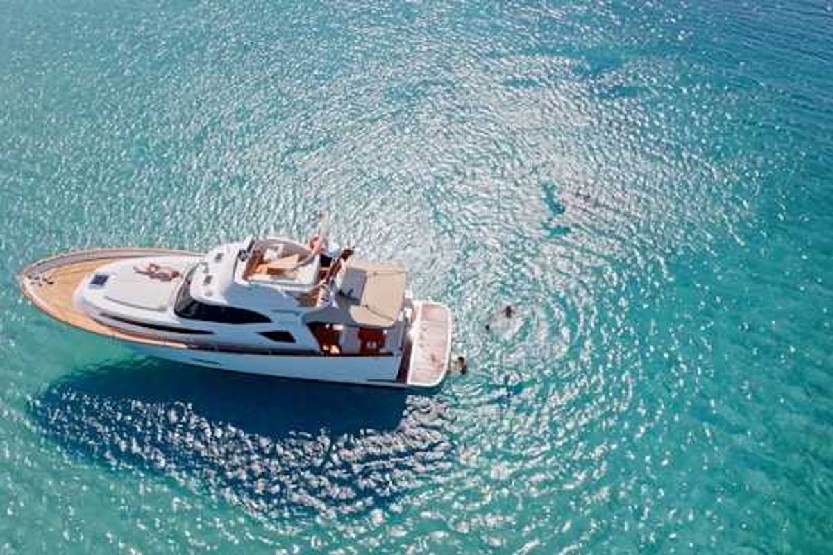 A yacht anchored in aqua blue water
